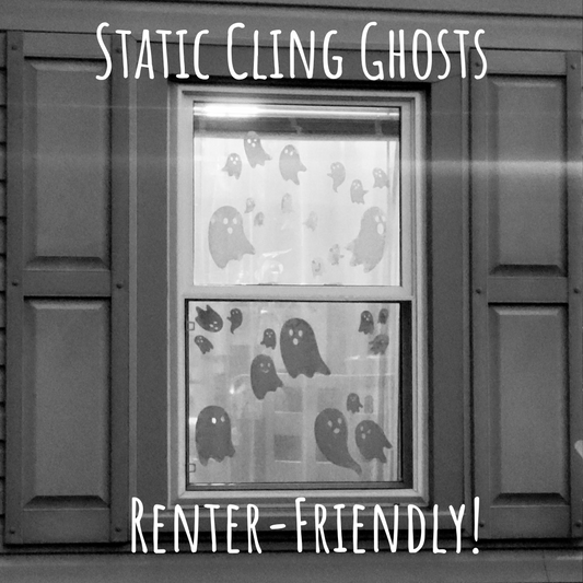 Window with ghost-themed static cling decorations on a gray background