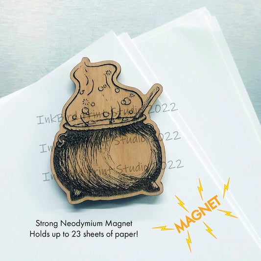 Bubbling Cauldron fridge magnet, laser-etched wood, neodymium backing, dark finish, intricate cauldron design, strong hold.