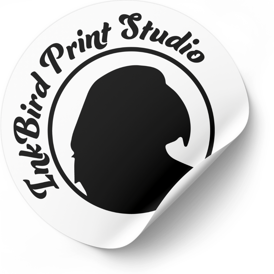 A circular white sticker or decal with a curled bottom-right corner, featuring the text 'InkBird Print Studio' in black script around a black silhouette profile on a white background.