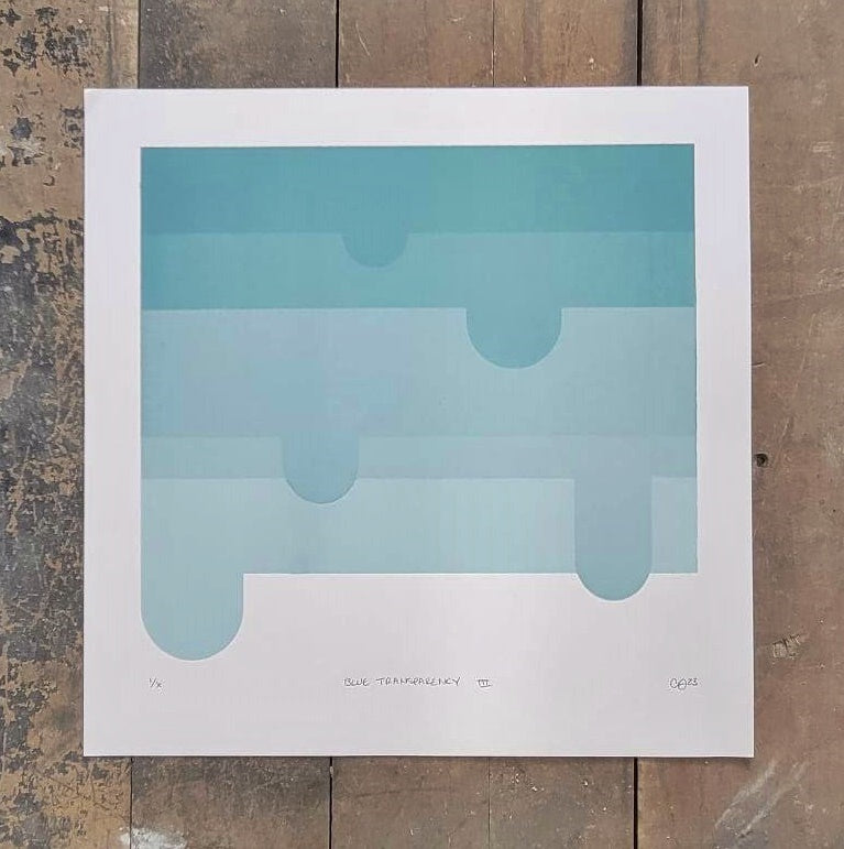 Set of 3 blue screen prints by Claire Davis of InkBird Print Studio; layered rounded blue vinyl shapes, handwritten notes, signature, on wood floor.