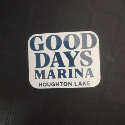 InkBird Print Studio LLC white vinyl die cut sticker with bold blue GOOD DAYS MARINA HOUGHTON LAKE text on black background.