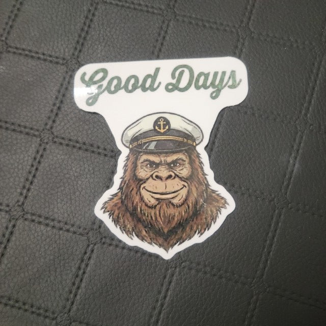 Premium vinyl die cut sticker shows a cheerful ape in sailor hat beneath Good Days, durable adhesive, textured black background.