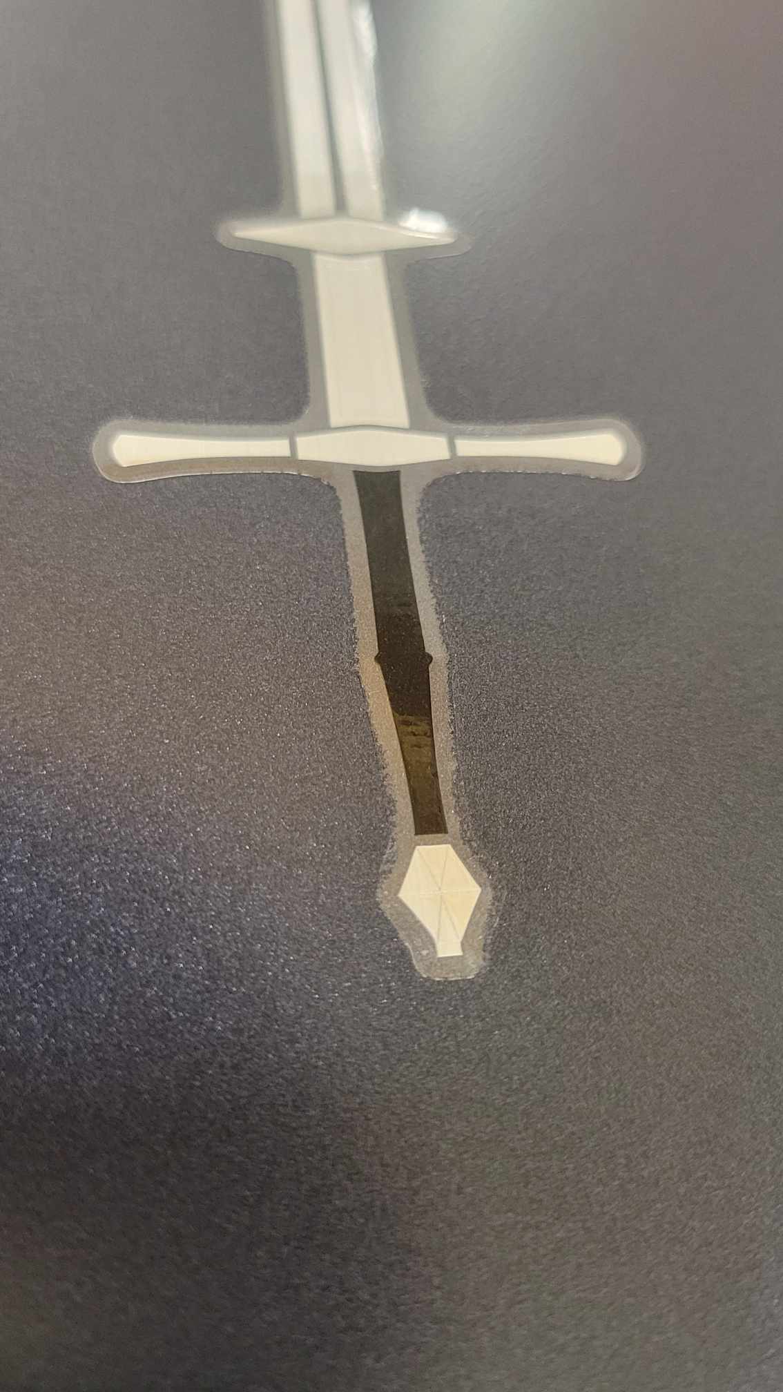Vinyl Zweihander sword sticker by InkBird Print Studio, metallic silver/black foil, white blade, detailed crossguard, bold design.