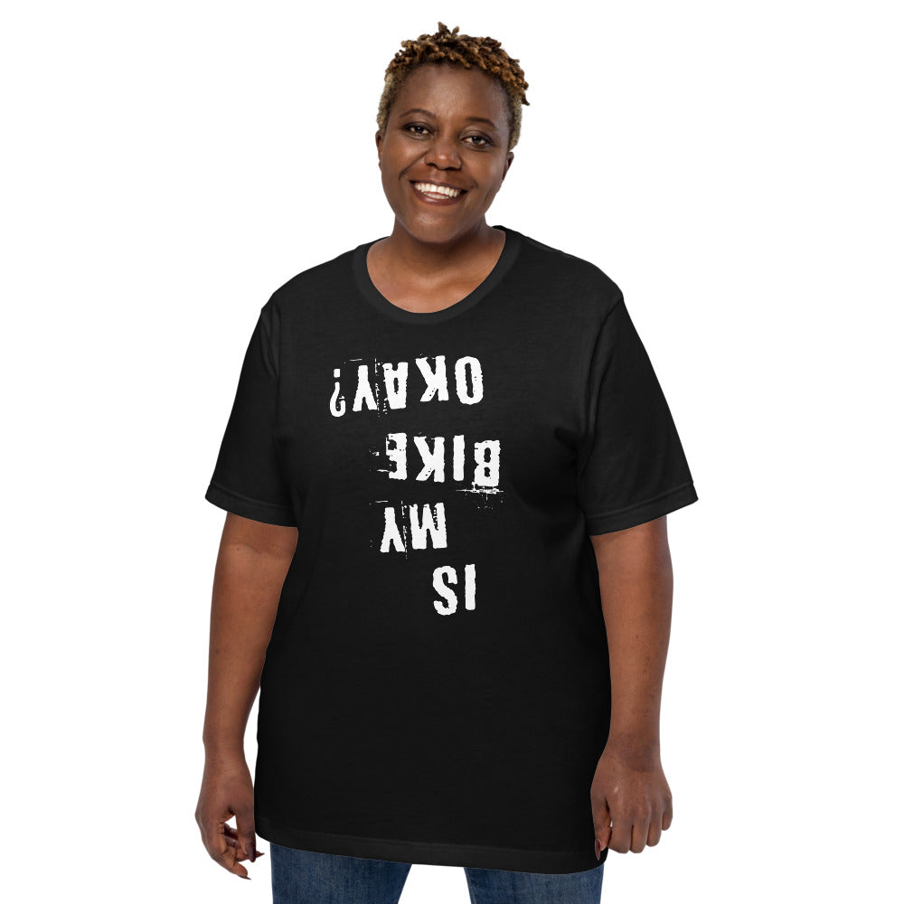 Black cotton Is My Bike Okay? T-shirt with white distressed upside-down text, modeled on plain background; unisex fit, MTB gift.