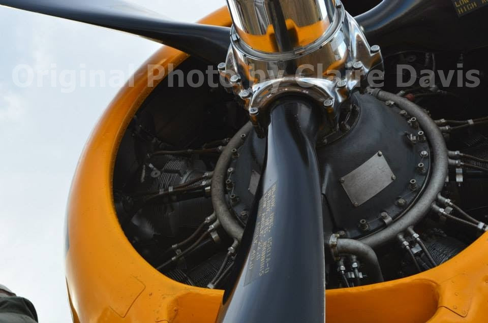 The original photo that inspired the print of a WWII TMB-3 Avenger airplane vinyl sticker with yellow cowling, propeller detail, photo by Claire Davis of InkBird Print Studio