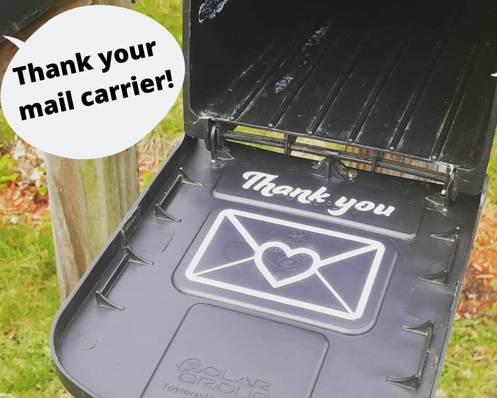 Vinyl “Thank your mail carrier!” decal features a white envelope with a red heart; adhesive, mailbox-ready, fits standard mailbox lid.