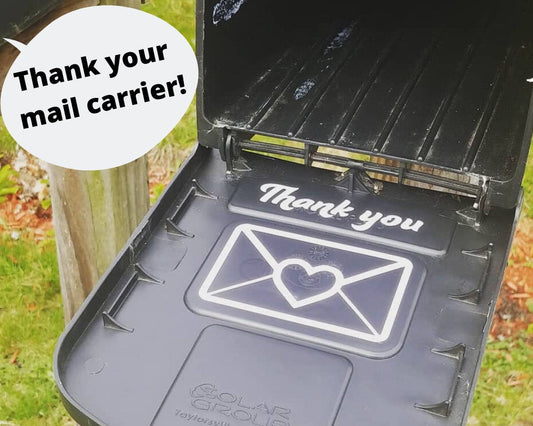 Vinyl “Thank your mail carrier!” decal features a white envelope with a red heart; adhesive, mailbox-ready, fits standard mailbox lid.
