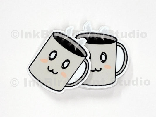 Vinyl coffee cup sticker by InkBird Print Studio with two cartoon mugs, rosy cheeks, clinking, and steamy details; die-cut, adhesive-backed.