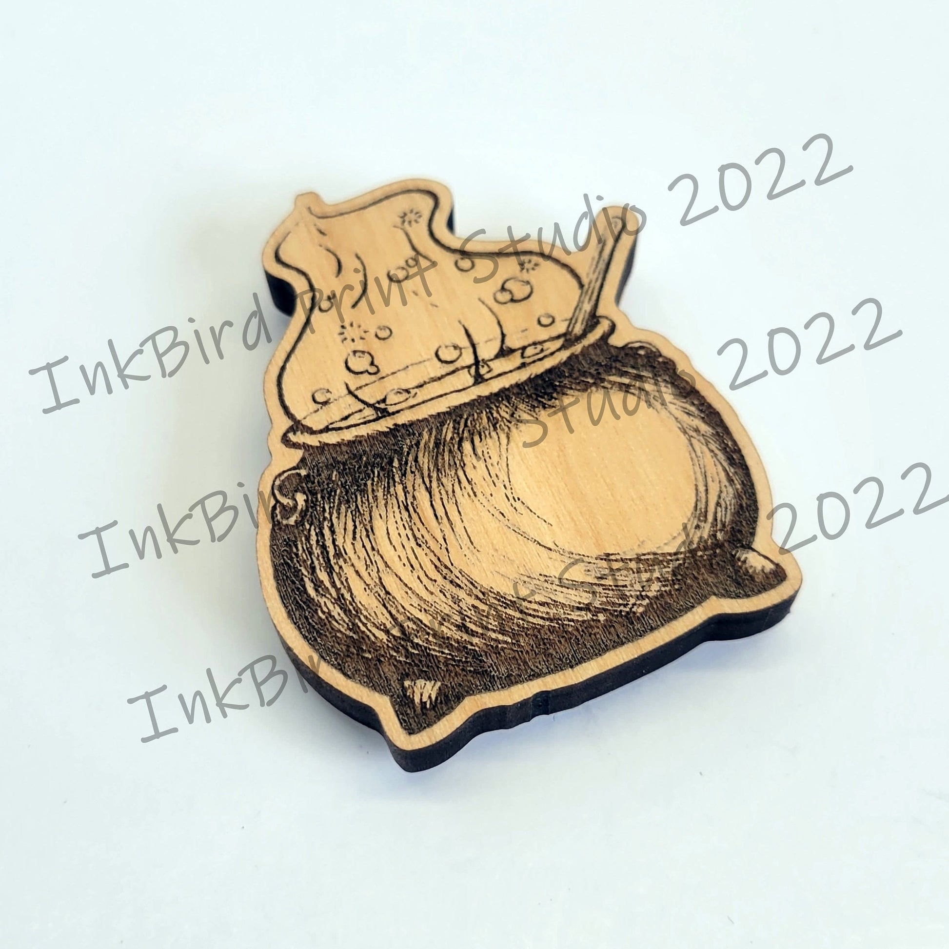 Wooden magnet with spooky cauldron and bubbling potion design laser-etched on natural wood, neodymium backing, by InkBird Print Studio.